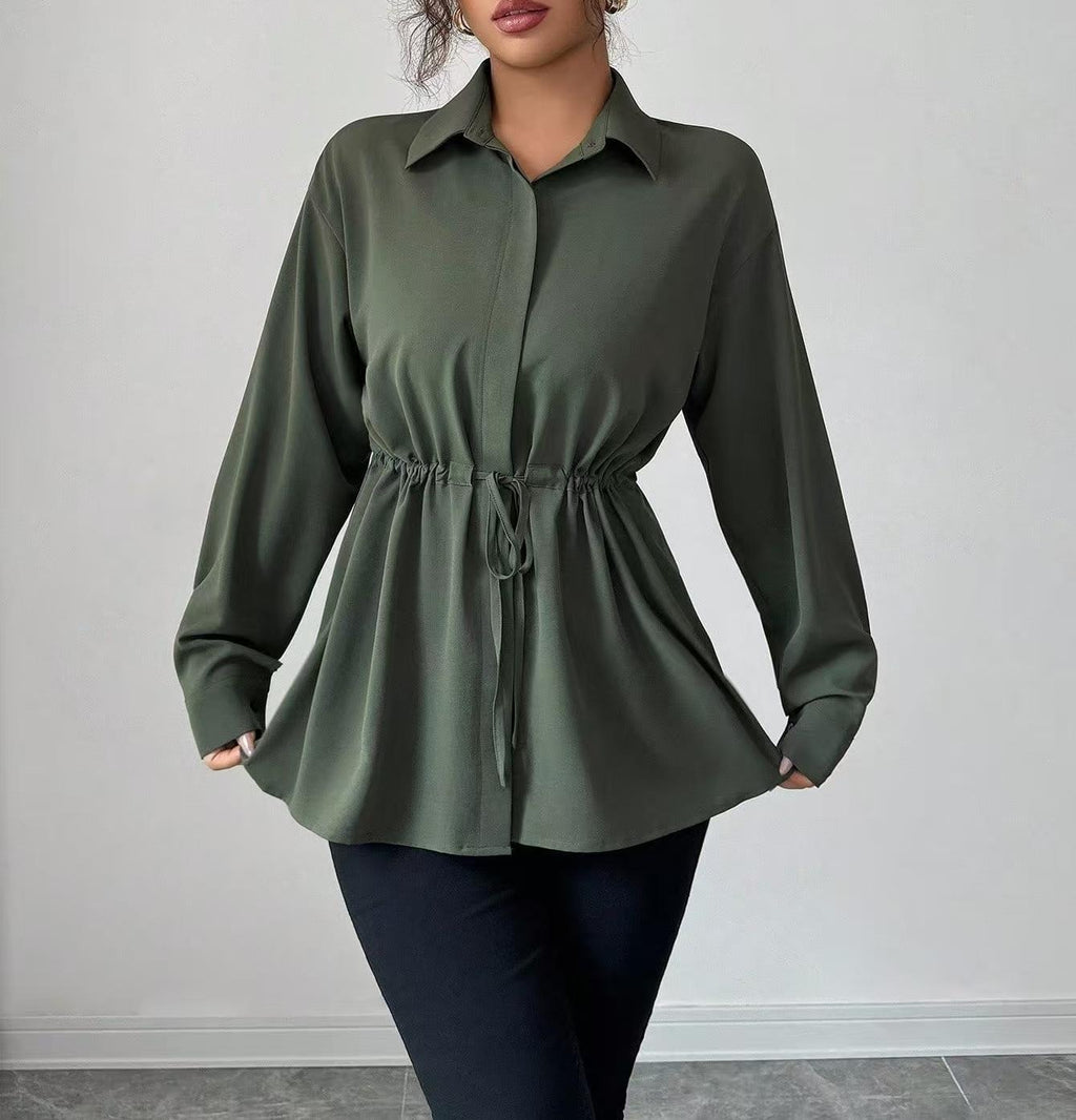 Model holding the hem of an olive drawstring-waist blouse
